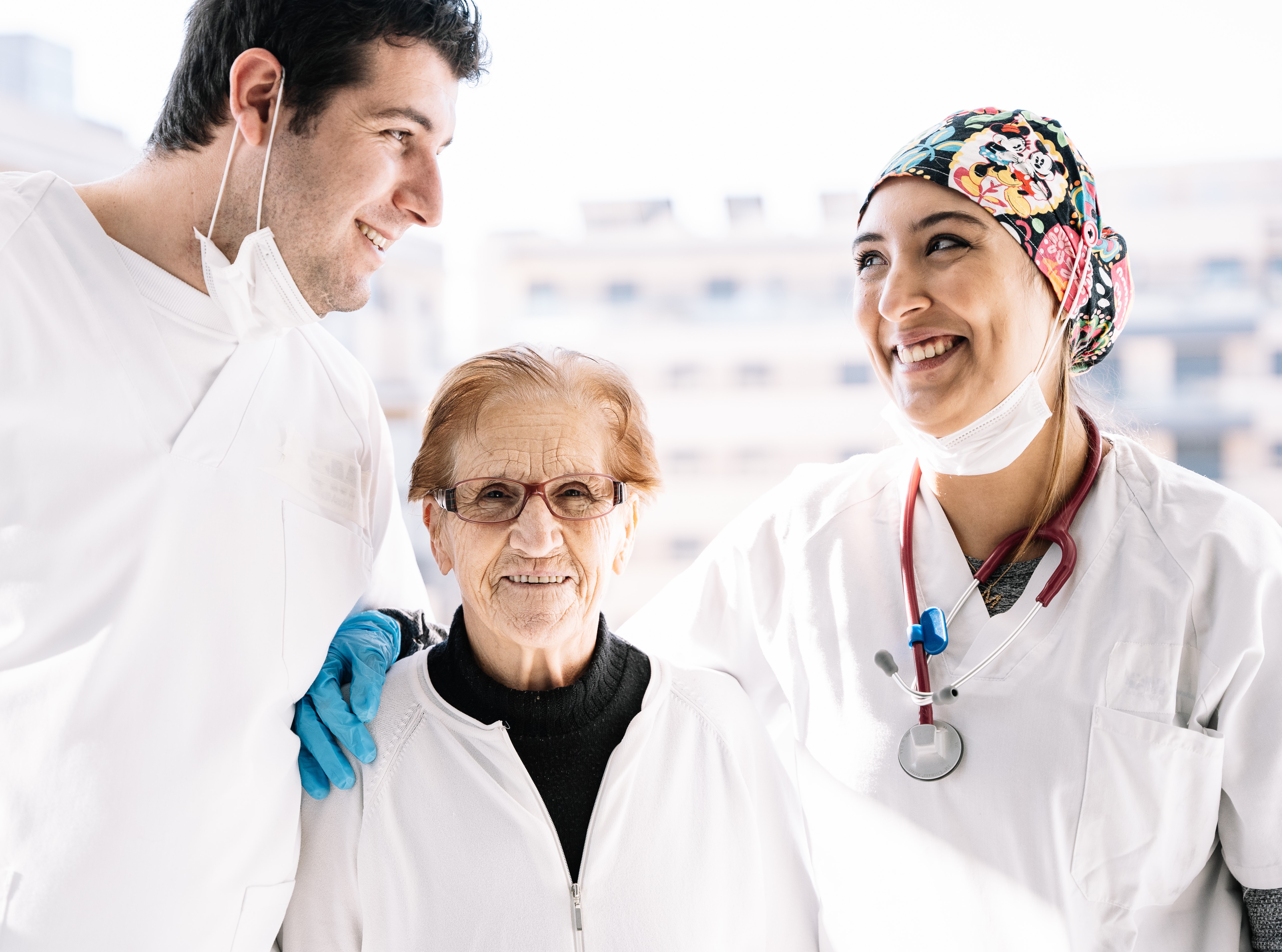 Professional care team smiling with an older client in a supportive environment